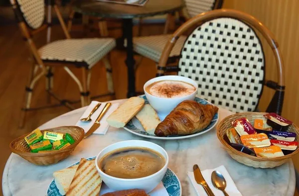 Coffee, a croissant and toast on a table at Cafe St Pierre.
